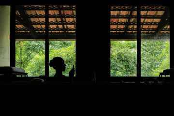 Shadow of the woman bathing in the luxury bathtub at the hotel using her phone