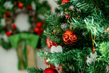 Christmas decorations. Christmas tree with various red Christmas decorations: balls, hearts, icicles, stars
