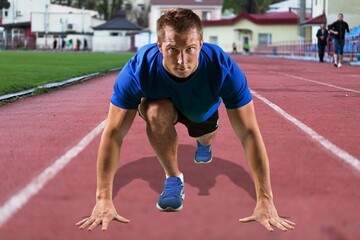 young sportsman running track on stadium.