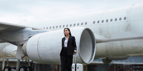 Professional Asian business woman executive wearing suit walking in the airport looking away thinking of success, leadership Confident and professional young Asian businesswoman