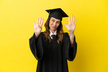 Middle aged university graduate isolated on yellow background counting nine with fingers