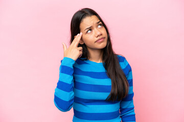 Young Colombian woman isolated on pink background with problems making suicide gesture