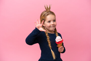 Little caucasian girl with a cornet ice cream isolated on pink background