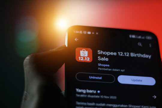 pringsewu, Lampung; November 28, 2023; man's hand holding a cell phone with the shopee 12.12 online shopping application on an Android smartphone. optical beacon. editorial
