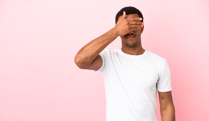 African American man on copyspace pink background covering eyes by hands. Do not want to see something - obrazy, fototapety, plakaty