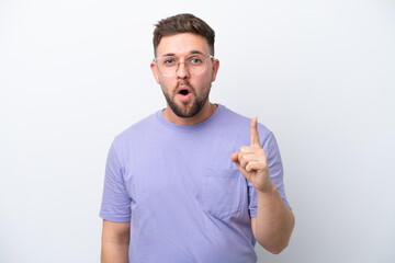 Young caucasian man isolated on white background intending to realizes the solution while lifting a finger up