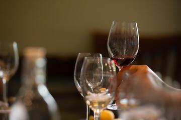 Wine glasses on a table in a restaurant, shallow depth of field