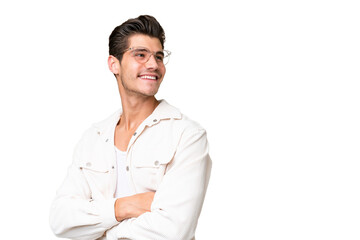 Young handsome caucasian man over isolated background with arms crossed and happy