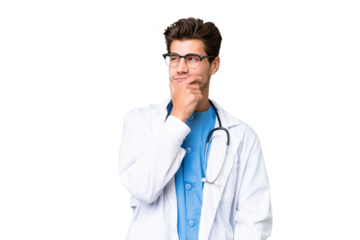 Young doctor man over isolated background having doubts and with confuse face expression