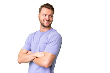 Young handsome caucasian man over isolated chroma key background with arms crossed and happy