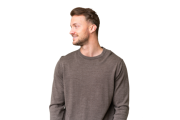 Young handsome caucasian man over isolated chroma key background looking side