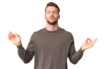 Naklejka premium Young handsome caucasian man over isolated chroma key background in zen pose
