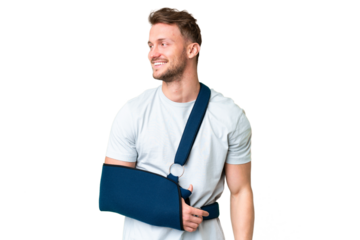 Young caucasian man with broken arm and wearing a sling over isolated chroma key background looking side