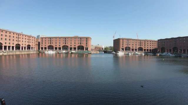 Liverpool, England, September 9, 2023: SLOW MO - The Royal Albert Dock is a complex of dock buildings and warehouses in Liverpool. Designed by Jesse Hartley and Philip Hardwick, it was opened in 1846.
