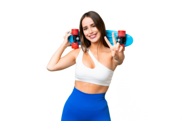 Young beautiful woman over isolated chroma key background with a skate doing victory gesture