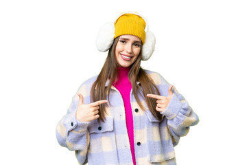 Young woman wearing winter muffs over isolated chroma key background proud and self-satisfied