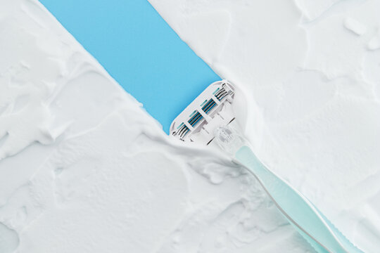 Razor glides through creamy foam, embodying the essence of a smooth, indulgent shave