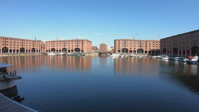 Liverpool, England, September 9, 2023: SLOW MO - The Royal Albert Dock is a complex of dock buildings and warehouses in Liverpool. Designed by Jesse Hartley and Philip Hardwick, it was opened in 1846.