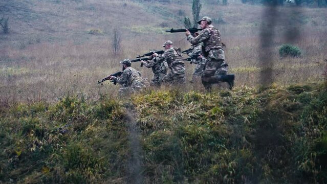 Military Detachment Attacks Across the Meadow Deployed in Formation