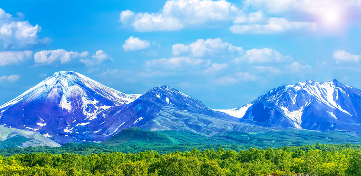 Avachinsky and Kozelsky volcanoes in Kamchatka in the autumn with a snow covered top
