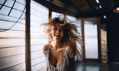 Candid shot of cheerful young woman with messy hair smiling wide - obrazy, fototapety, plakaty