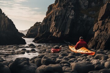 Man kayaking on a rocky beach in Brittany, France. Copy space, A red kayak and a man camping on coastal rocks, AI Generated - obrazy, fototapety, plakaty
