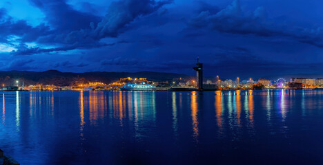 night view of the port of Almeria city with fantastic reflections of different colors in the water...