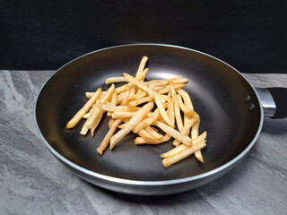 French fries piled up in the pan