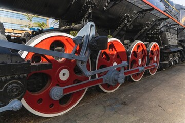 Mechanical wheels of a transport steam locomotive on rails