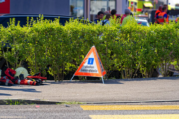 Fire and smoke at recycling collection point with mobile road sign at Swiss City of Wallisellen on...