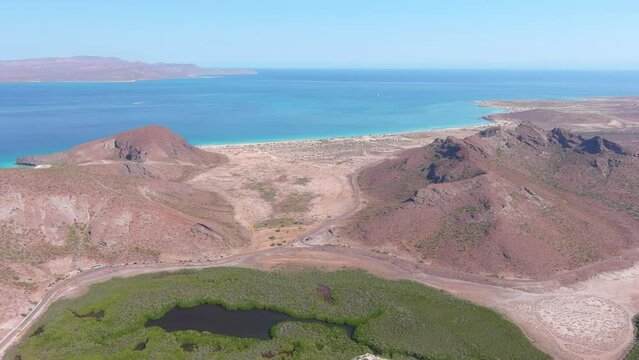 Mexico, La Paz: Aerial view of Tecolote Beach (Playa El Tecolote) with clear turquoise waters of Gulf of California - landscape panorama of Latin America from above