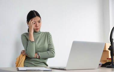 Asian women selling clothes live on their phones are stressed over problems that arise during the sale.