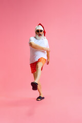 Full length portrait of Santa Claus dressed for summer cheerfully and joyfully walks to meet the...