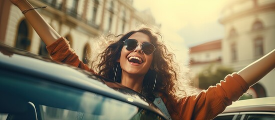 Happy girl grooving in car jamming to pop tunes dancing in city center copy space image