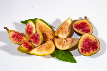 three pieces of figs with different colored fillings, dark red, young and bright yellow. on a plain...