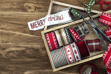 Christmas gift wrapping. Christmas ribbons and antique scissorson on a wooden background.  Natural Christmas background, banner. 

