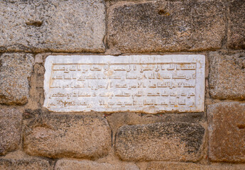 Inscription of a commemorative plaque with calligraphy in Arabic language sculpted in marble of...