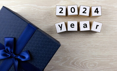2024 year by wooden cubes with gift blue box