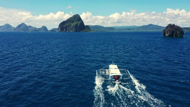 Sea, boat and mountain or drone vacation or holiday adventure, tropical beach or summer. Bangka, ocean in nature for peace travel or island location trip for outdoor, blue sky cruise in Philippines