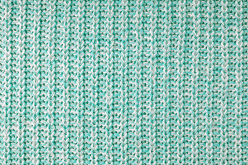 Jersey textile background , turquoise white melange knitted wool fabric. Woolen knitwear, sweater, pullover surface texture, textile structure, cloth surface, weaving of knitwear material