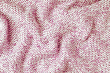 Red and white color melange knitting cashmere wool cloth texture. Background of crumpled, wrinkled knit fabric, textile structure, cloth surface, weaving of knitwear material.