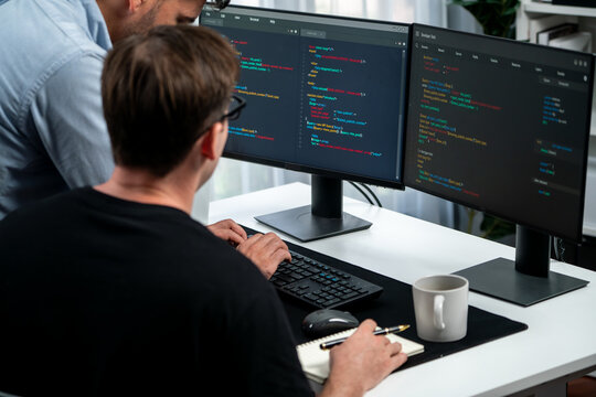 IT developers discussing online software development information on pc screen, creating program coding for latest version application on website. Concept of brainstorming firmware updated. Sellable.