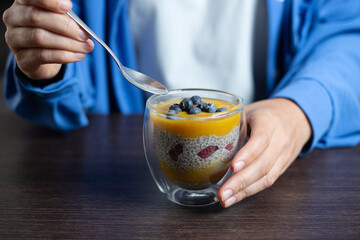 Healthy vegan dessert - chia pudding with mango aHealthy vegan dessert - chia pudding with mango and berries. Vegan eating.nd berries. Home cooking. - obrazy, fototapety, plakaty
