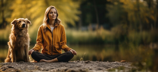 Young woman immersed in meditation next to her attentive golden retriever in autumnal natural scenery, banner.