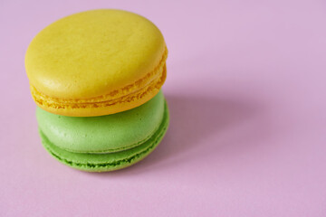 Colorful macaroons on a pink background. Copy space.