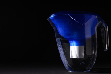 Modern water filter on a black background