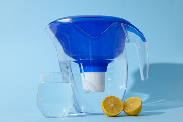 Water filter with fresh lemons and glass