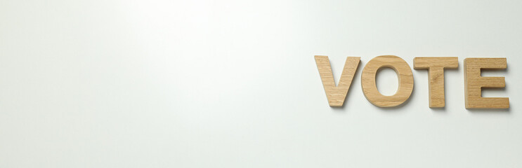 Word Vote from wooden letters on white background, space for text