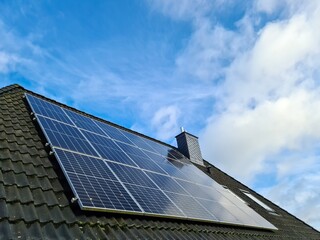 Solar panels producing clean energy on a roof of a residential house
