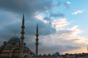 Fototapeta na wymiar Islamic photo. Eminonu New Mosque or Yeni Cami with dramatic clouds at sunset